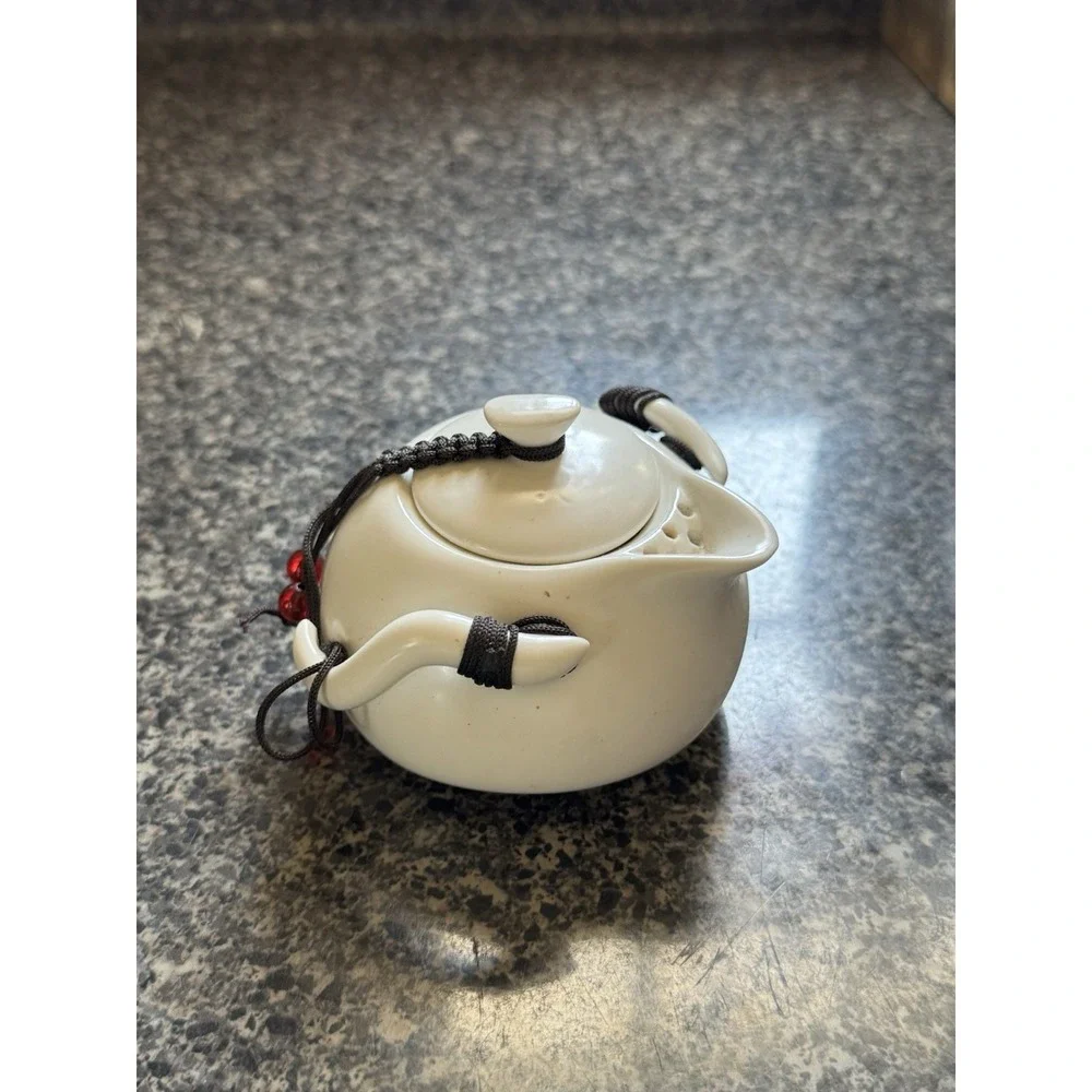 Compact travel tea pot white ceramic with decorative cord